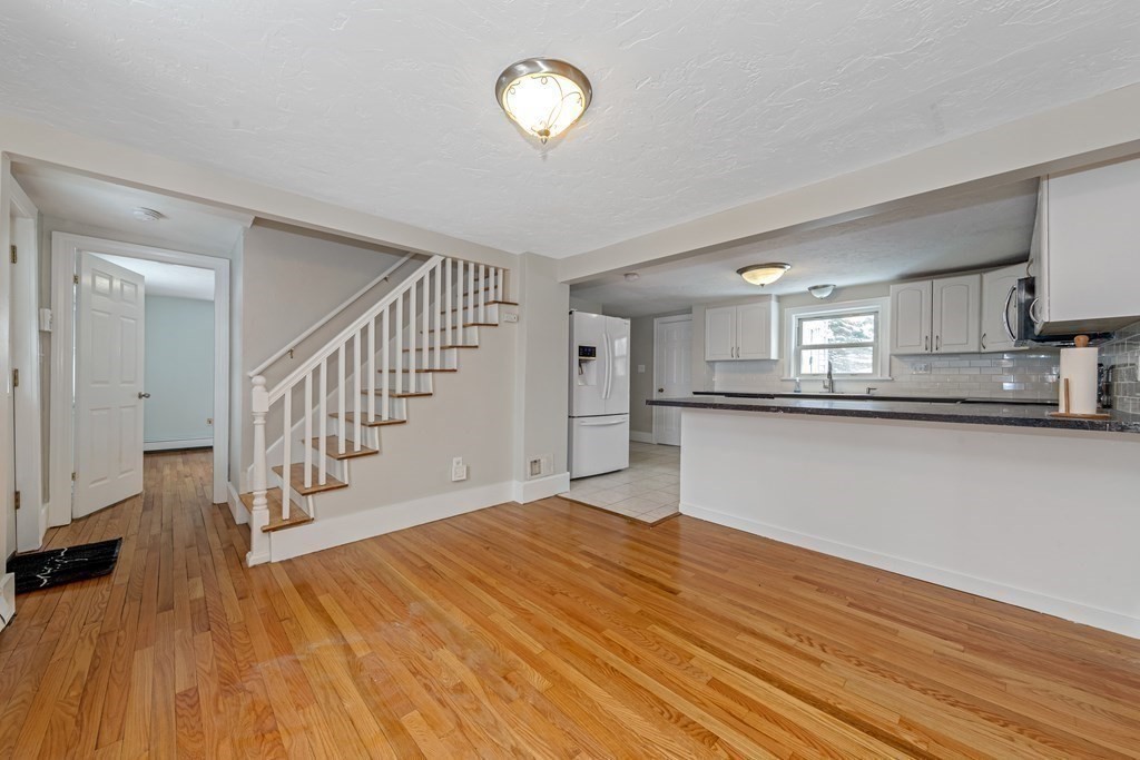 76 Rockefeller Street Randolph, MA 02368 - Photo 9 of 40 a view of a kitchen with wooden floor and a sink