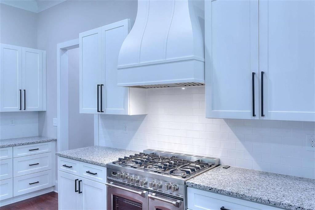 2053 John Stowe Road Monroe, GA 30656 - Photo 17 of 66 a kitchen with granite countertop a stove and a sink
