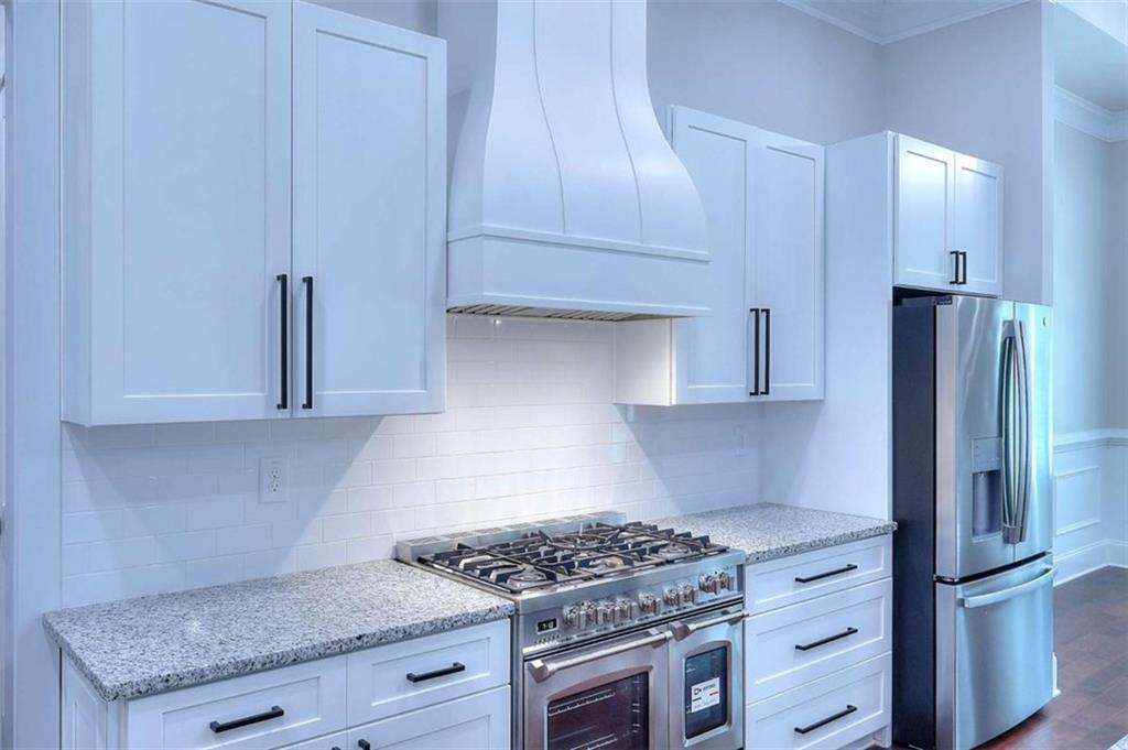 2053 John Stowe Road Monroe, GA 30656 - Photo 18 of 66 a kitchen with granite countertop a stove and a refrigerator