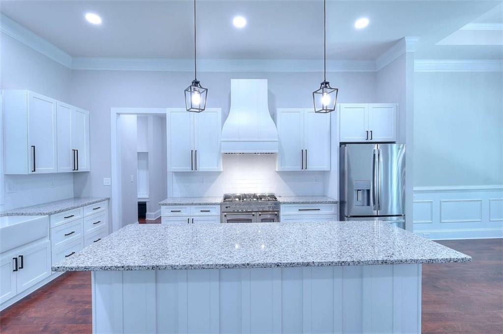 2053 John Stowe Road Monroe, GA 30656 - Photo 20 of 66 a kitchen with stainless steel appliances granite countertop a sink a refrigerator a center island a stove and cabinets