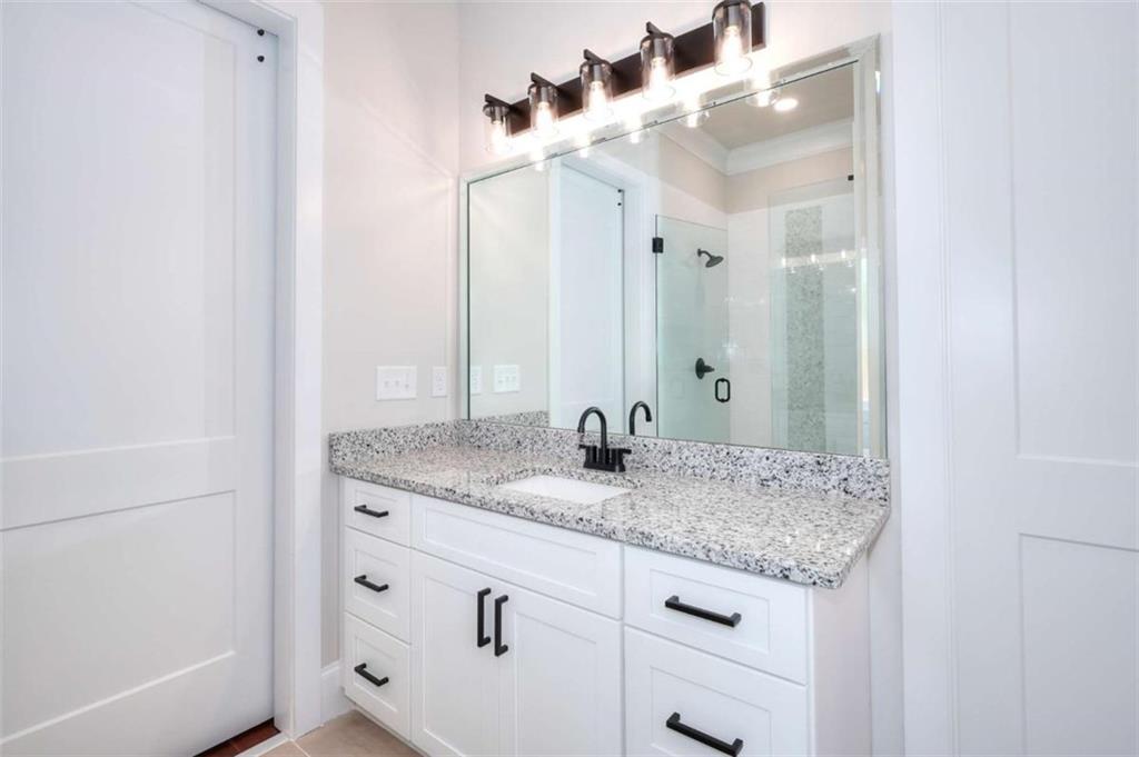 2053 John Stowe Road Monroe, GA 30656 - Photo 26 of 66 a bathroom with a granite countertop sink and a mirror