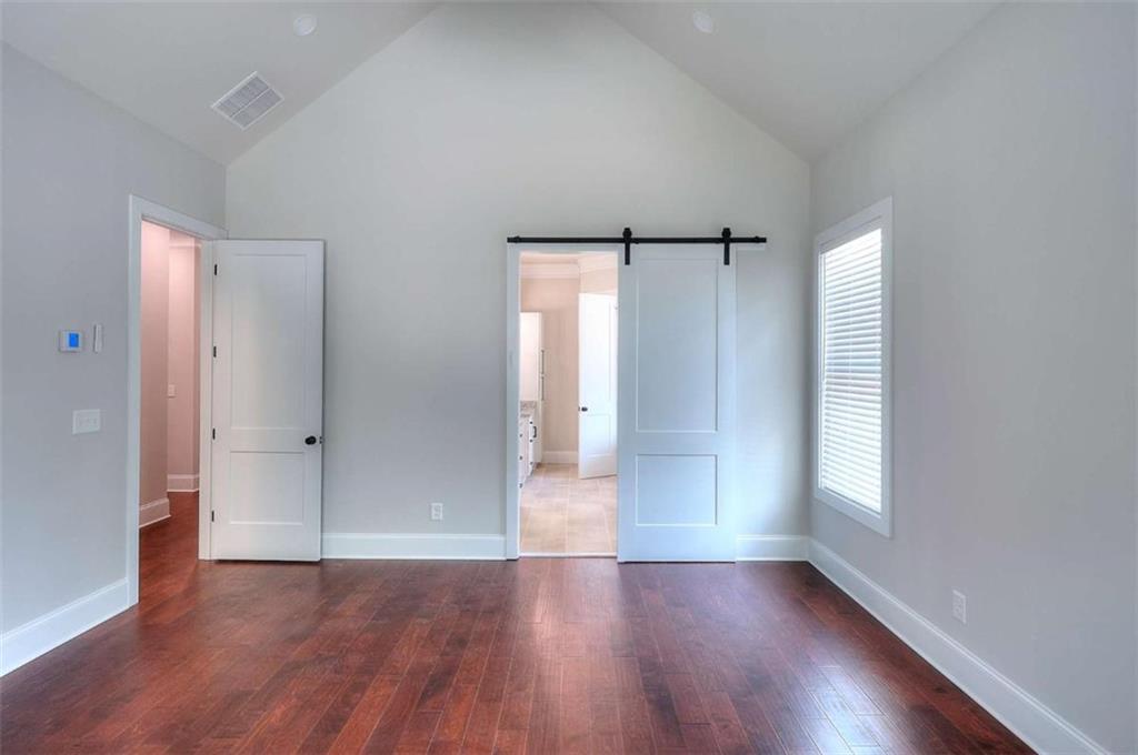 2053 John Stowe Road Monroe, GA 30656 - Photo 30 of 66 an empty room with wooden floor and windows