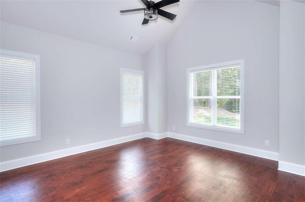2053 John Stowe Road Monroe, GA 30656 - Photo 31 of 66 an empty room with wooden floor fan and windows