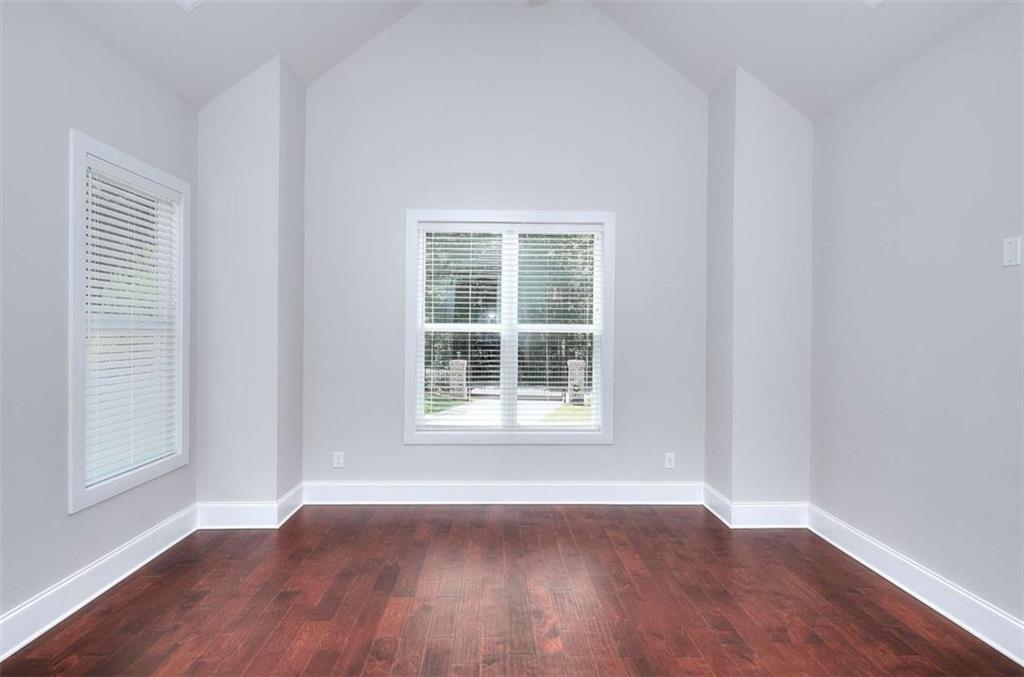2053 John Stowe Road Monroe, GA 30656 - Photo 32 of 66 an empty room with wooden floor and windows