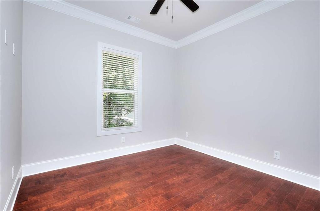 2053 John Stowe Road Monroe, GA 30656 - Photo 36 of 66 an empty room with a window and a ceiling fan