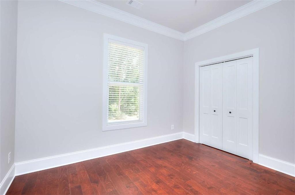 2053 John Stowe Road Monroe, GA 30656 - Photo 44 of 66 an empty room with wooden floor and windows