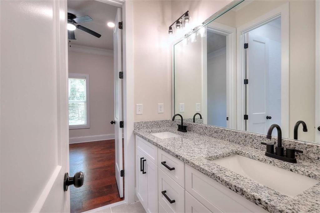 2053 John Stowe Road Monroe, GA 30656 - Photo 55 of 66 a bathroom with a granite countertop sink and a mirror