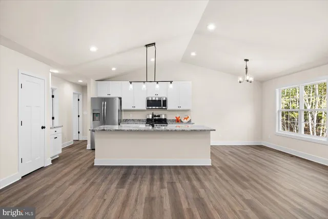a view of kitchen with sink microwave and refrigerator