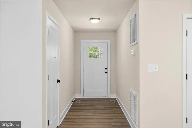 a view of a hallway with wooden floor