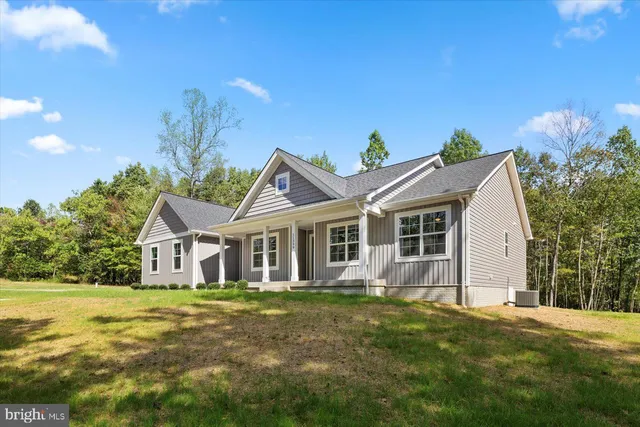 a view of a house with a yard and potted plants
