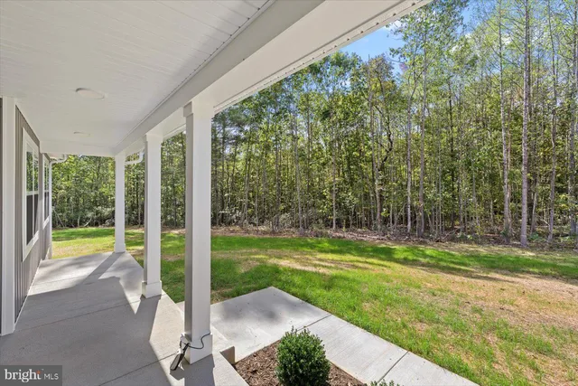 a view of a porch with furniture and garden