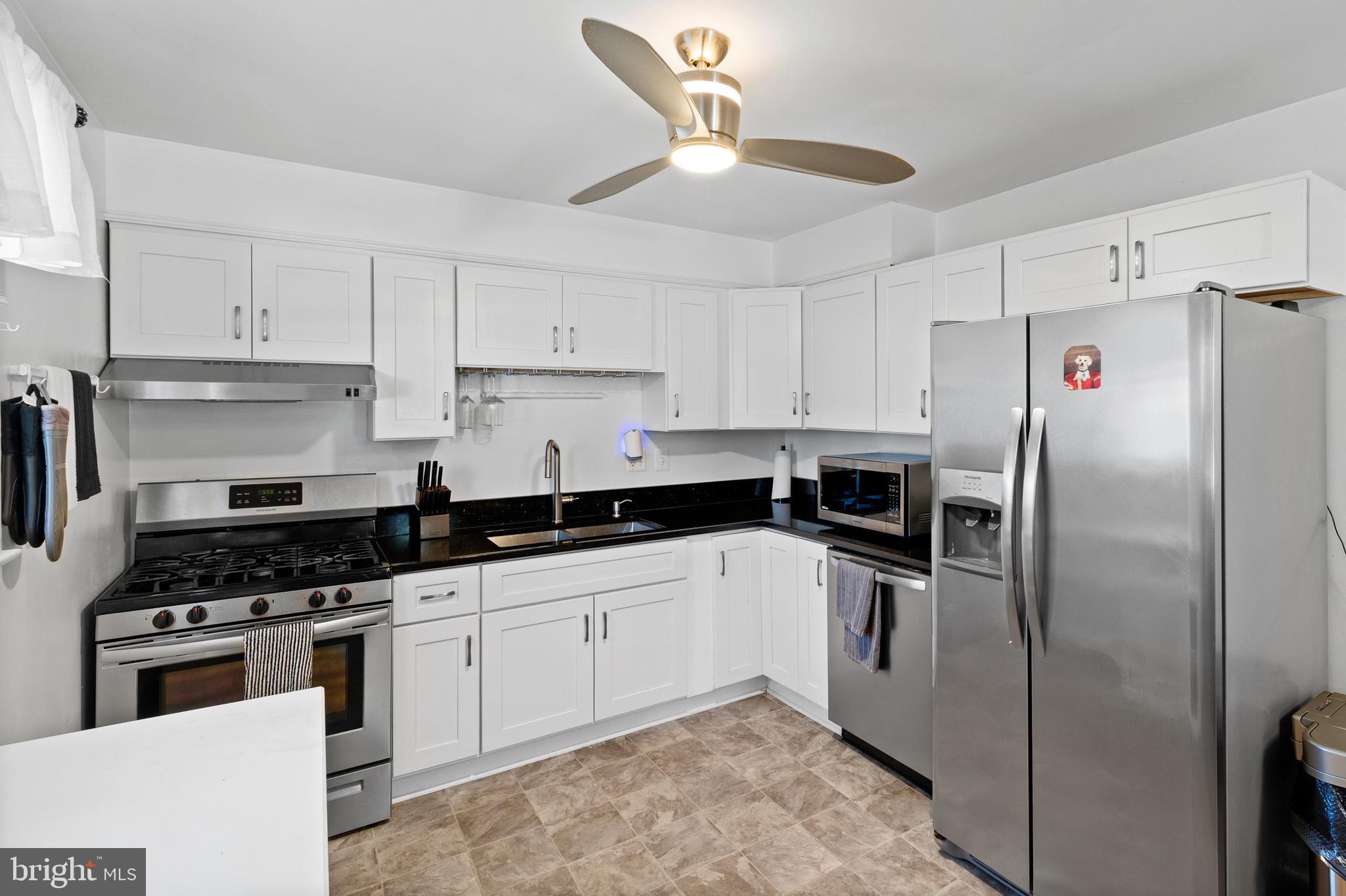8900 Townsend Lane Clinton, MD 20735 - Photo 3 of 30 a kitchen with cabinets stainless steel appliances and a counter space