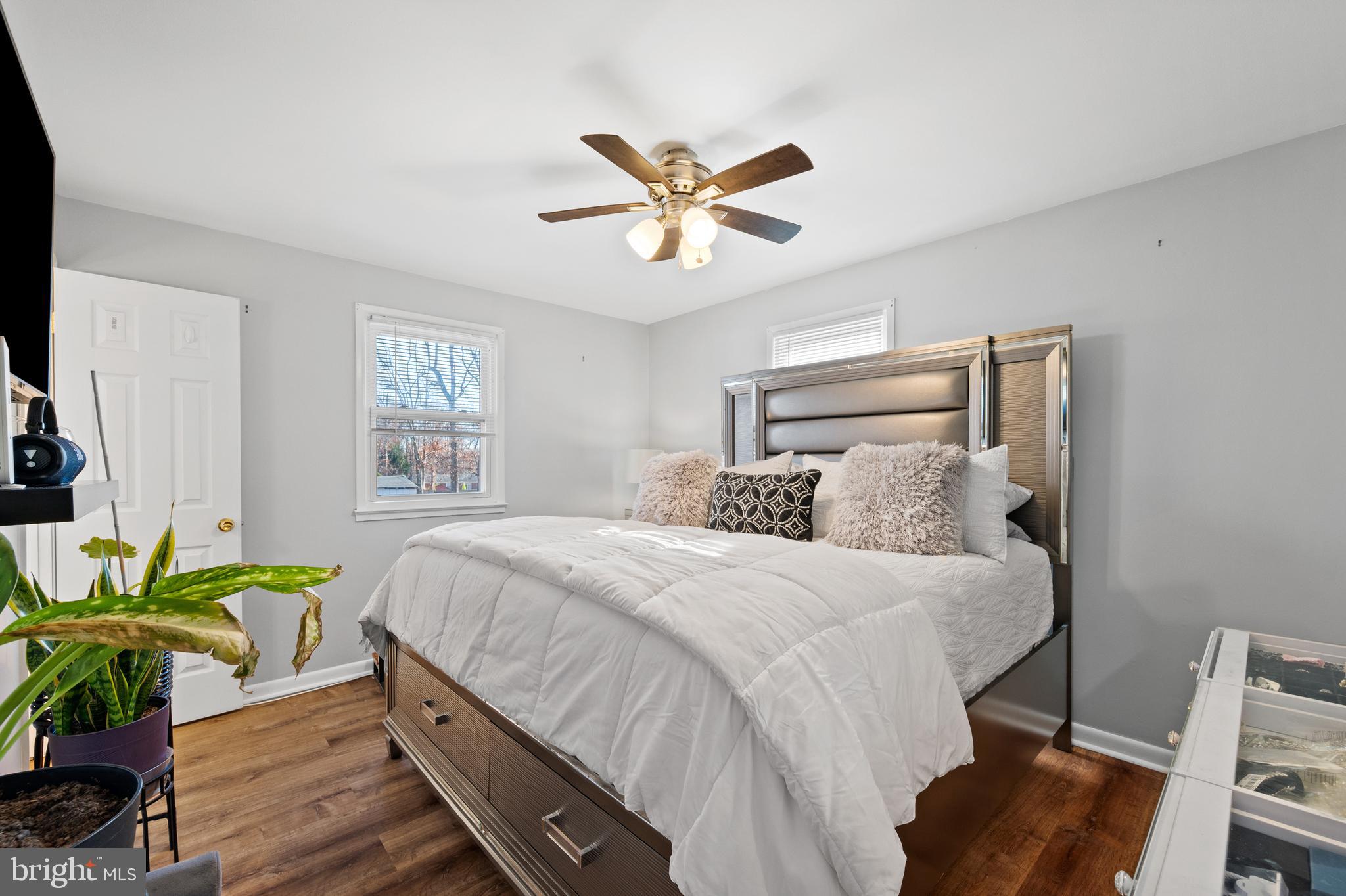 8900 Townsend Lane Clinton, MD 20735 - Photo 4 of 30 a bedroom with a bed a chandelier and a window