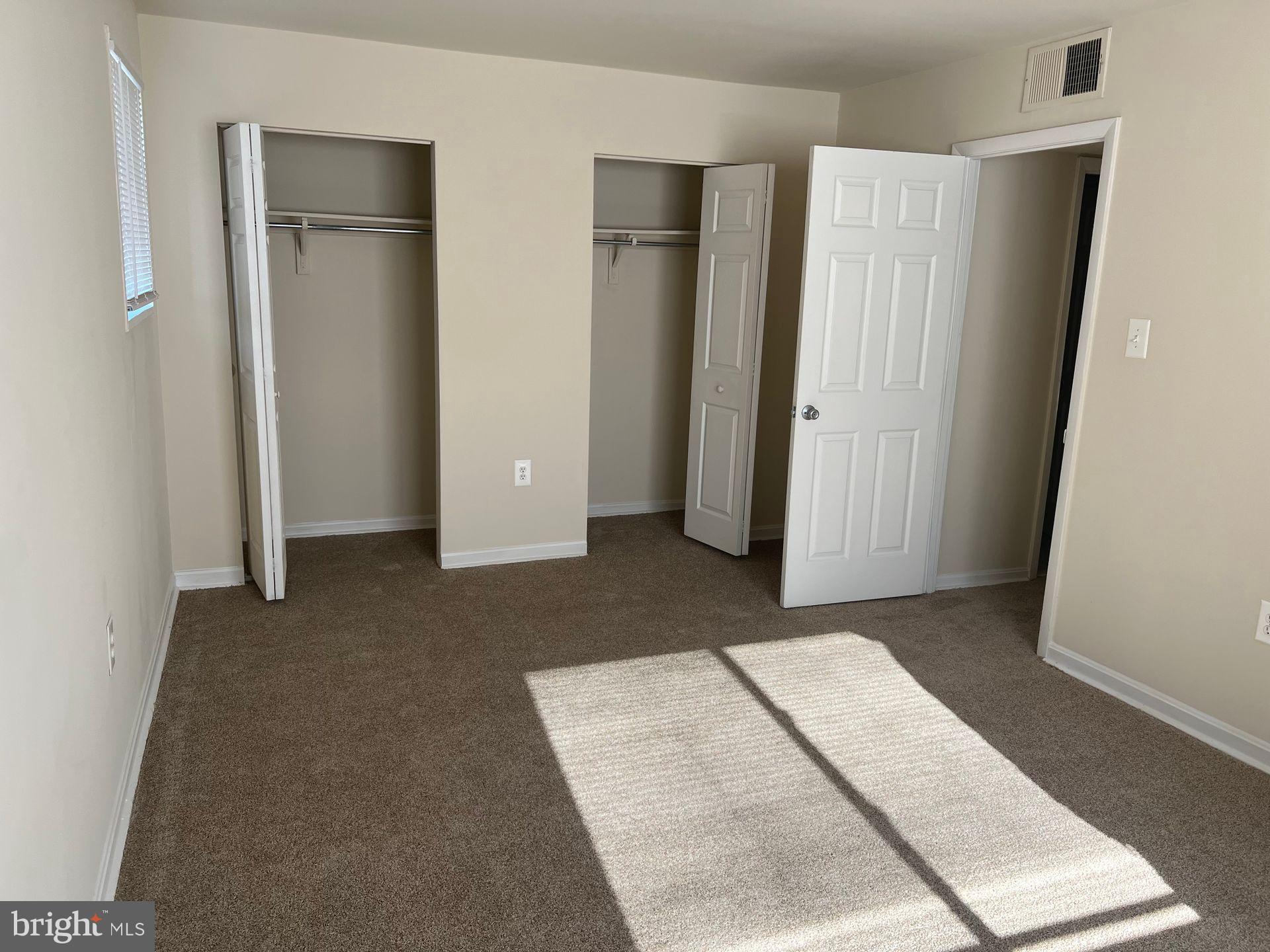 2500 Queens Chapel Road Hyattsville, MD 20782 - Photo 2 of 6 an empty room with closet and mirror