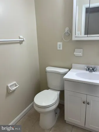 a white toilet sitting next to a bathroom sink