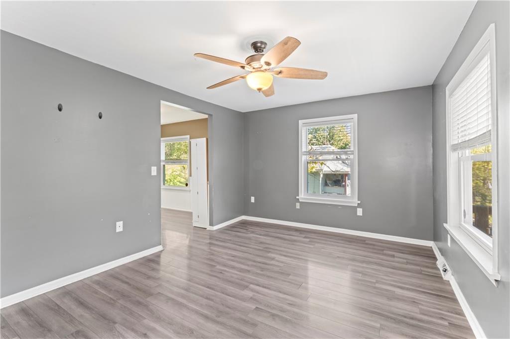 1217 25th Street Beaver Falls, PA 15010 - Photo 13 of 32 a view of an empty room with wooden floor and a window
