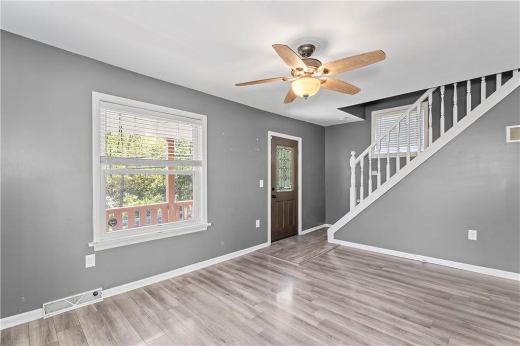 1217 25th Street Beaver Falls, PA 15010 - Photo 14 of 32 a view of an empty room with window and wooden floor