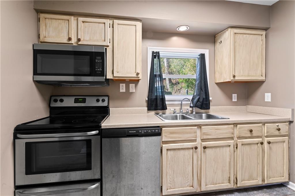 1217 25th Street Beaver Falls, PA 15010 - Photo 18 of 32 a kitchen with white cabinets and appliances