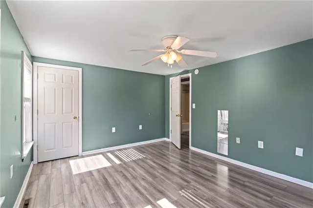 wooden floor in an empty room with a window