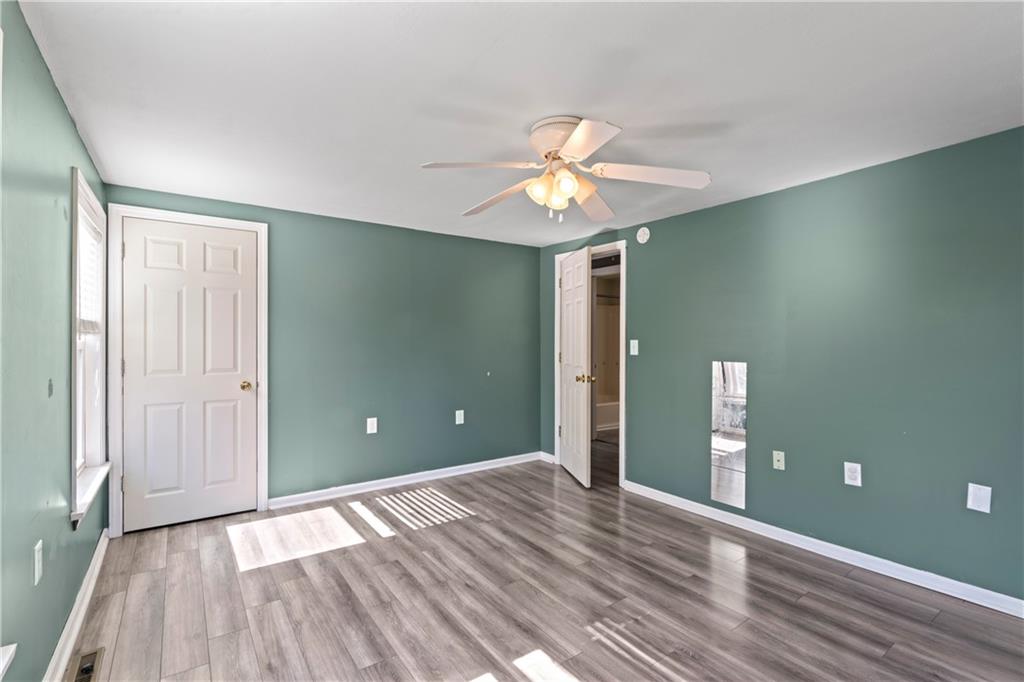 1217 25th Street Beaver Falls, PA 15010 - Photo 21 of 32 wooden floor in an empty room with a window