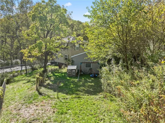 a yellow house in middle of the green field