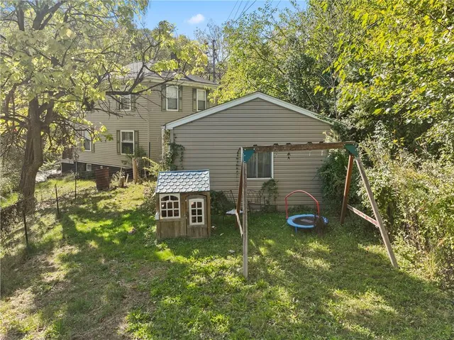 a backyard of a house with table and chairs
