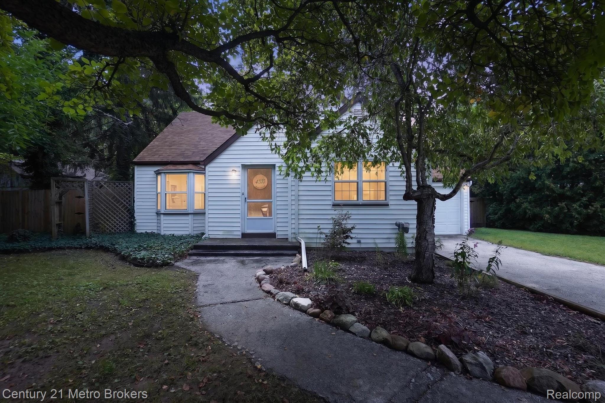 4575 Brockway Road Saginaw, MI 48638 - Photo 1 of 44 Light blue siding exterior with a brown shingled roof, featuring a bay window