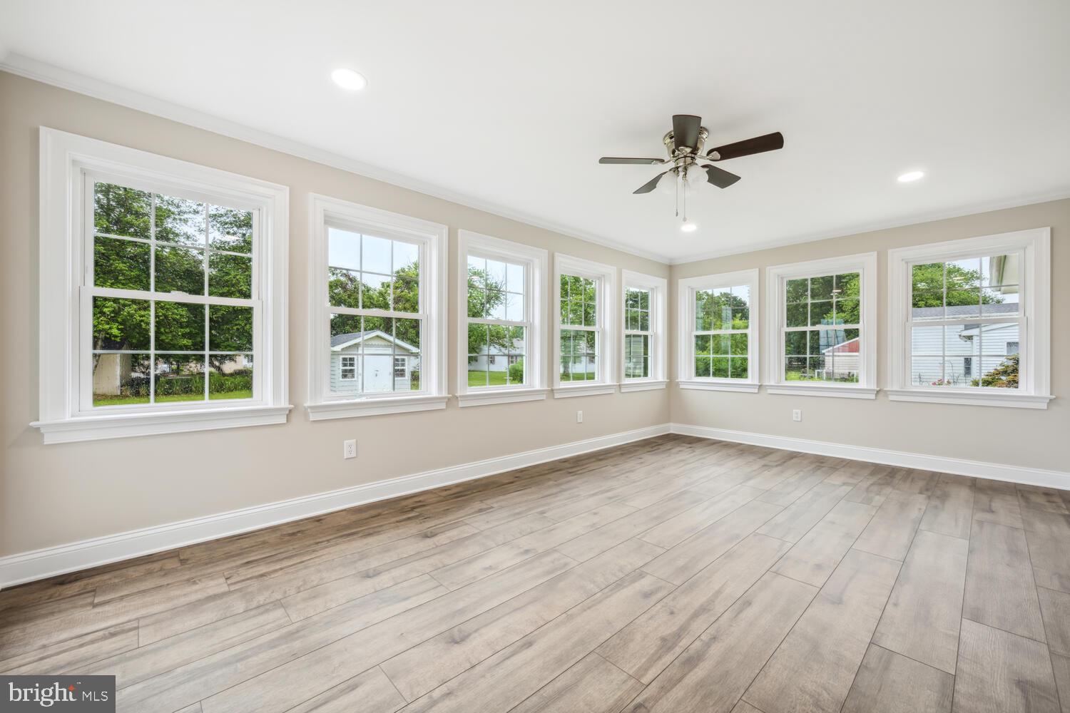 405 Collins Avenue Hurlock, MD 21643 - Photo 12 of 49 a view of an empty room with wooden floor and a window