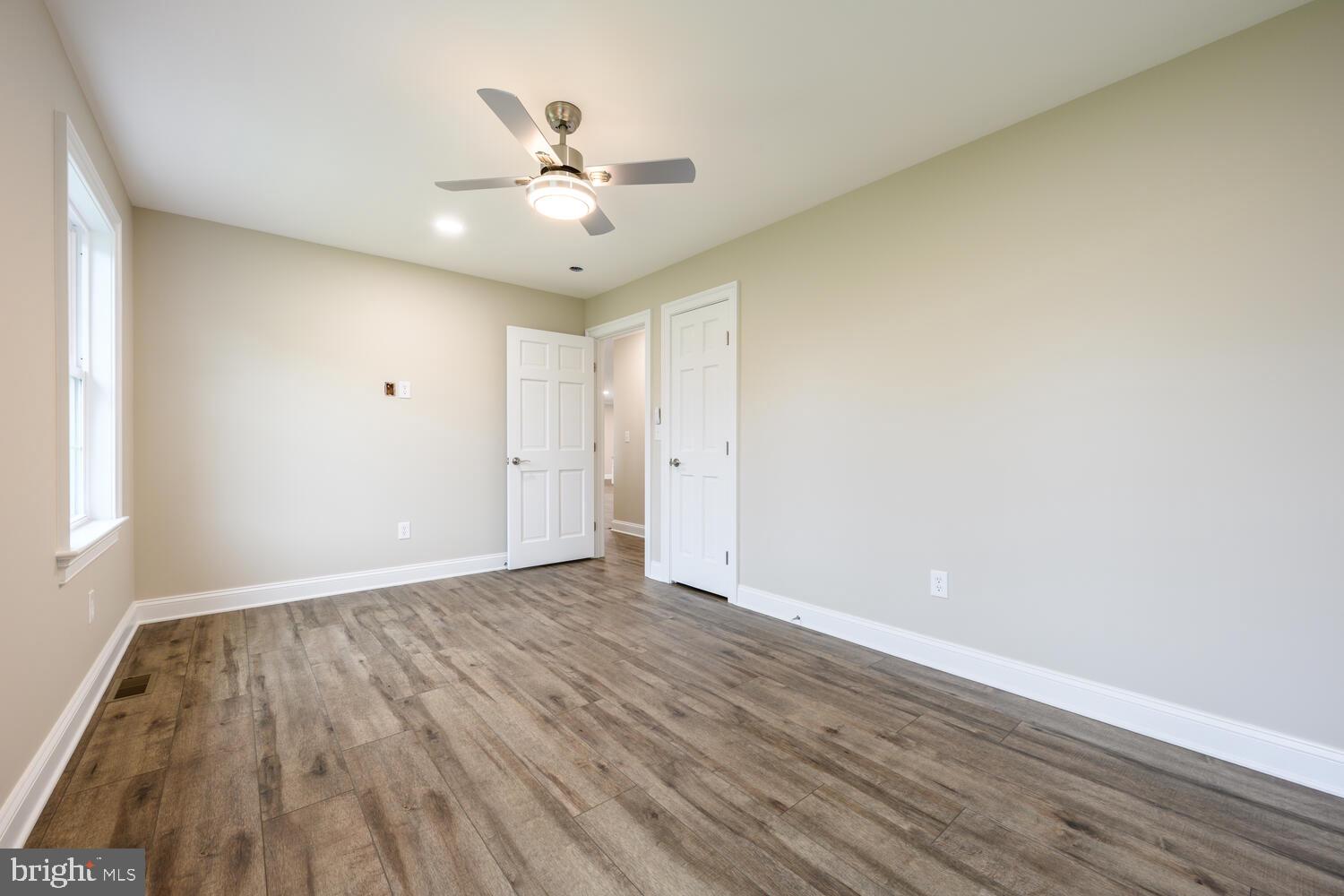 405 Collins Avenue Hurlock, MD 21643 - Photo 21 of 49 a view of an empty room with wooden floor and a window