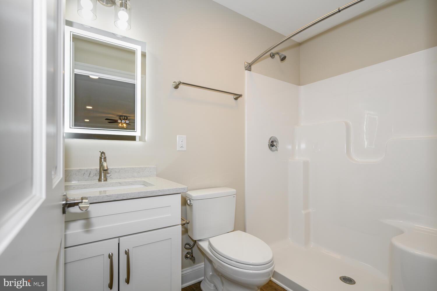 405 Collins Avenue Hurlock, MD 21643 - Photo 22 of 49 a bathroom with a sink a toilet and shower