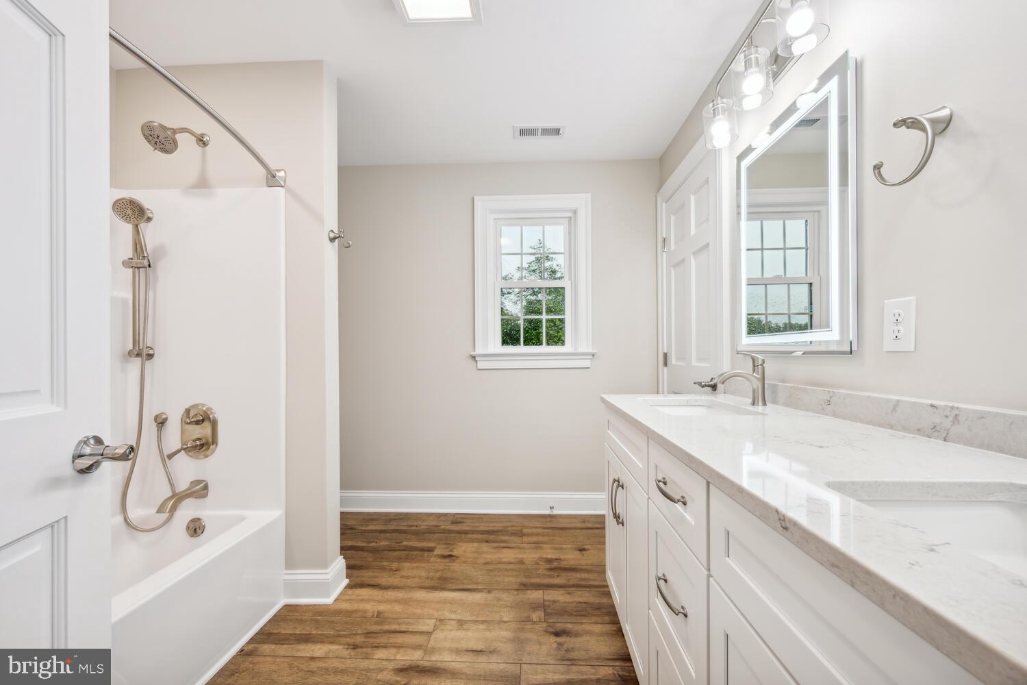 405 Collins Avenue Hurlock, MD 21643 - Photo 28 of 49 a bathroom with a granite countertop sink a toilet a vanity and shower