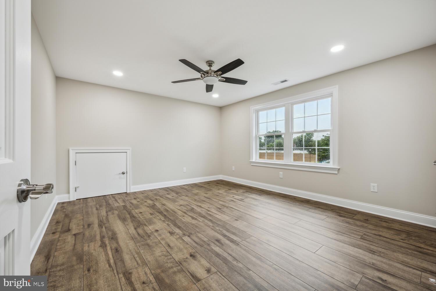 405 Collins Avenue Hurlock, MD 21643 - Photo 30 of 49 an empty room with wooden floor and windows