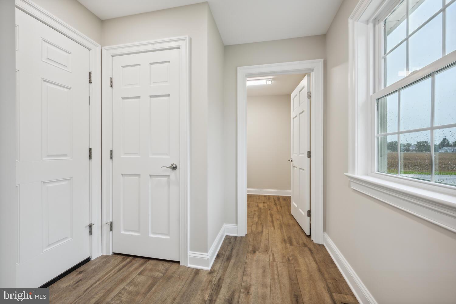 405 Collins Avenue Hurlock, MD 21643 - Photo 33 of 49 a view of a hallway with wooden floor and a bathroom