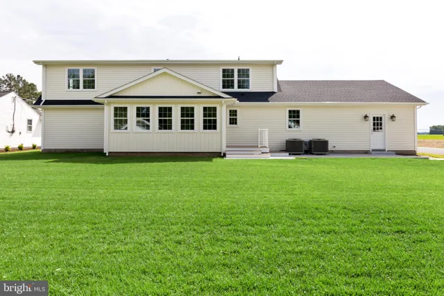 a view of a yard in front of a house with large trees