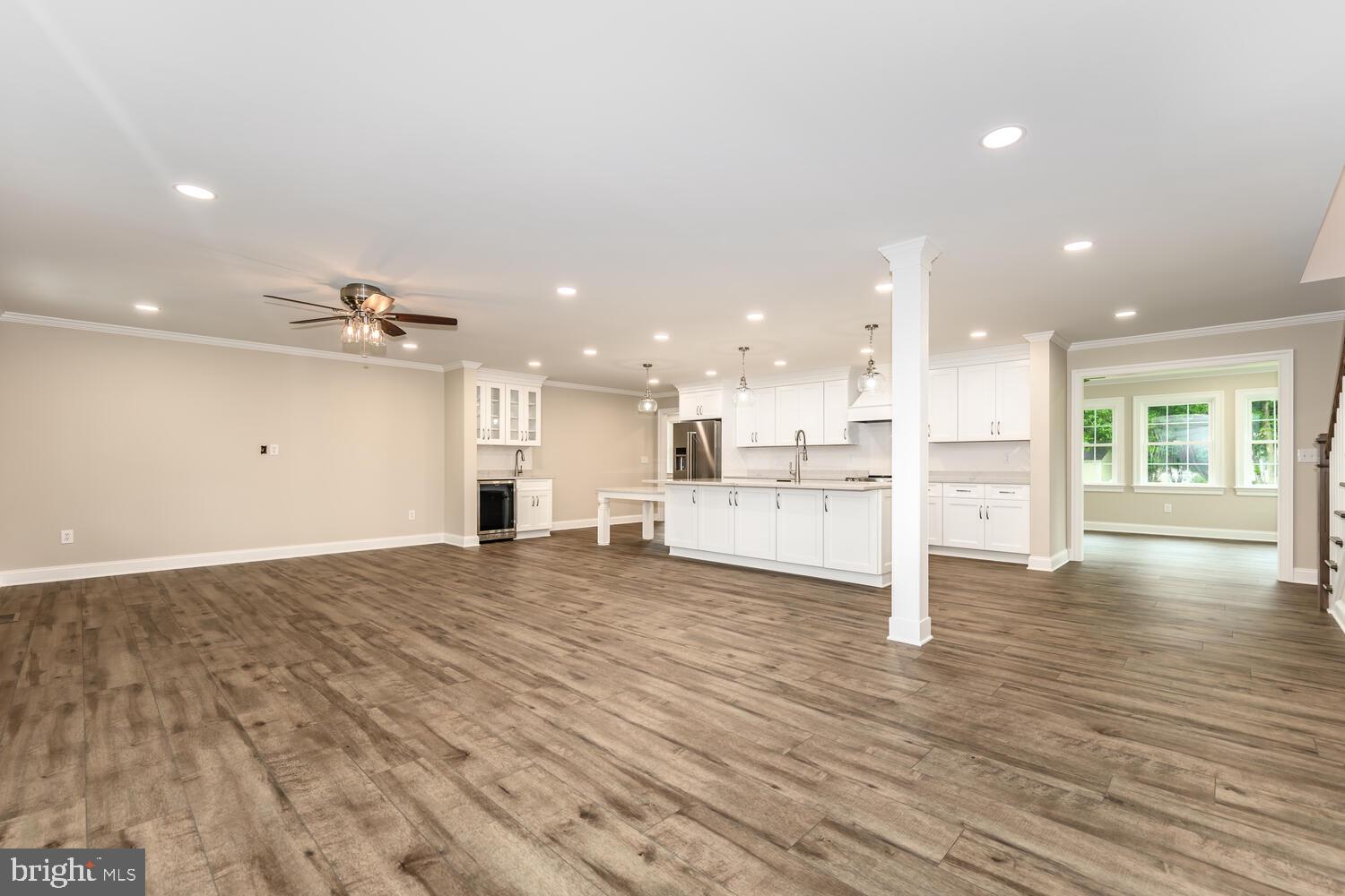 405 Collins Avenue Hurlock, MD 21643 - Photo 6 of 49 a view of a kitchen with kitchen island wooden floor appliances and a counter top space