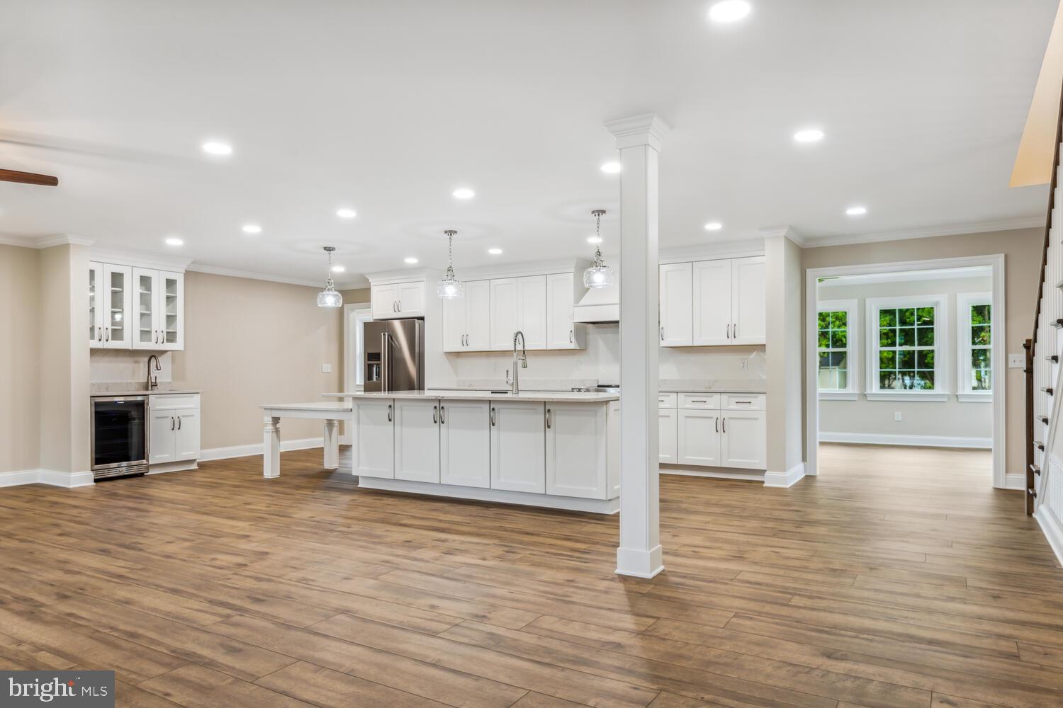 405 Collins Avenue Hurlock, MD 21643 - Photo 7 of 49 a large white kitchen with lots of counter space and windows