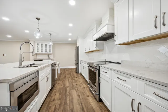 a large kitchen with a stove top oven