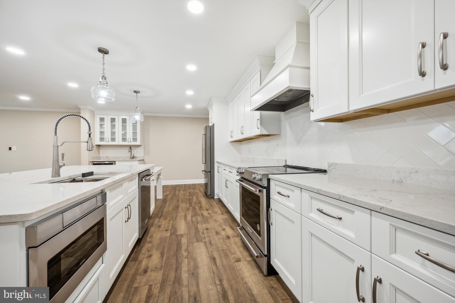405 Collins Avenue Hurlock, MD 21643 - Photo 9 of 49 a large kitchen with a stove top oven