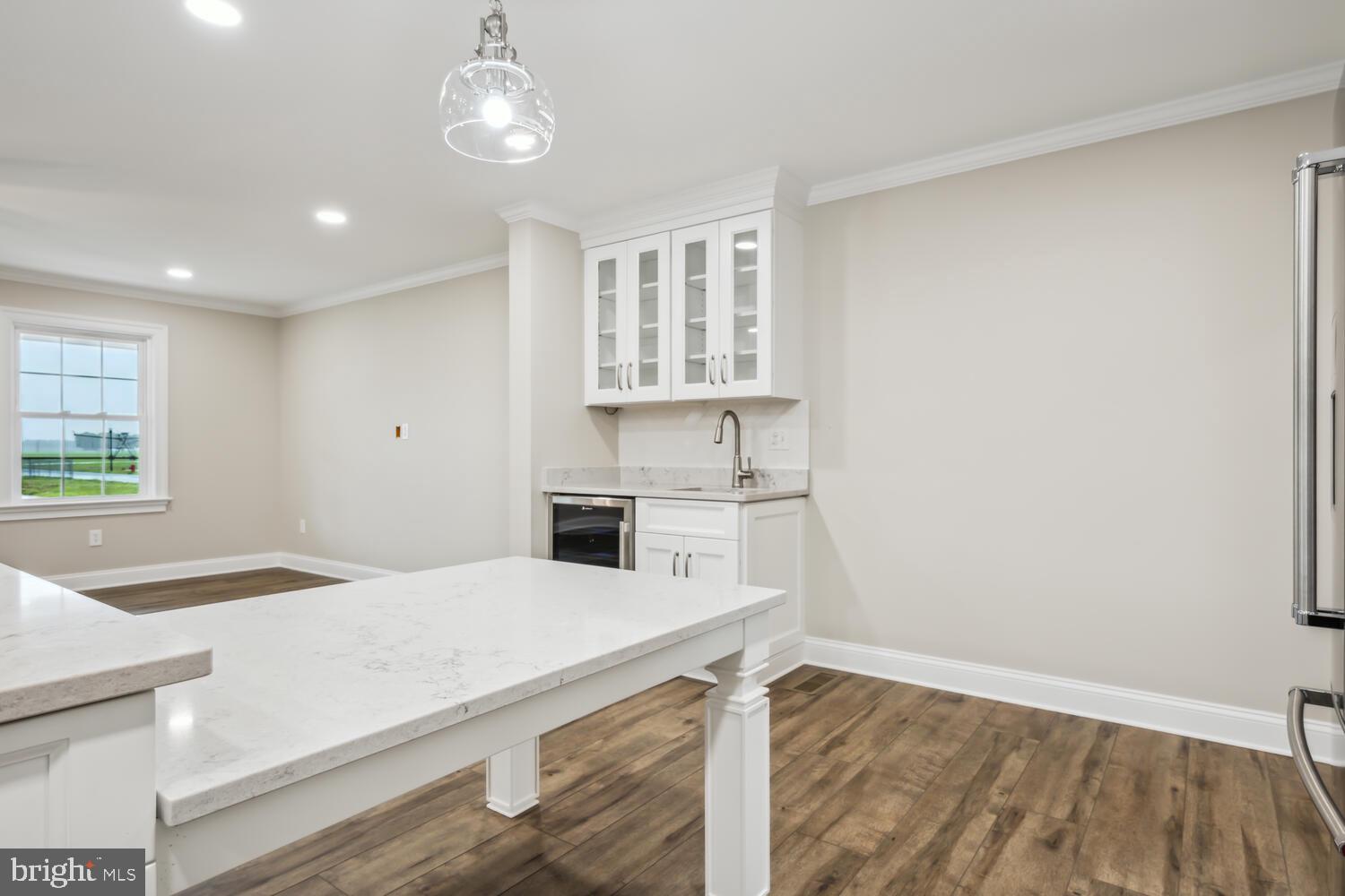 405 Collins Avenue Hurlock, MD 21643 - Photo 10 of 49 a kitchen with granite countertop a stove a sink and a microwave