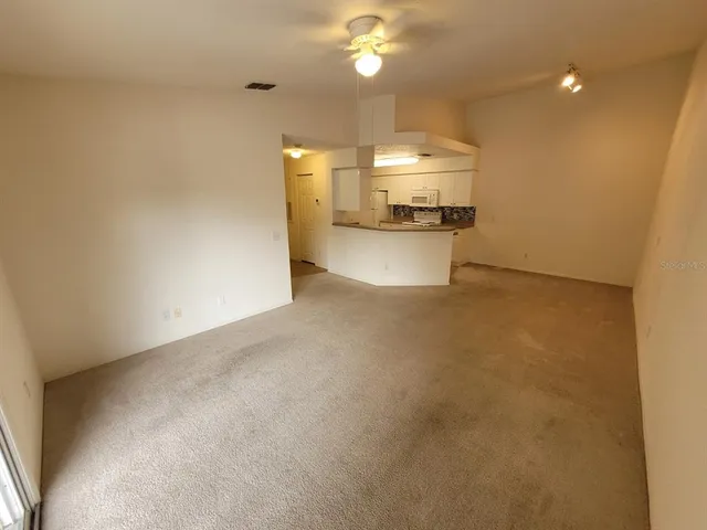 a view of a kitchen with a sink and a refrigerator