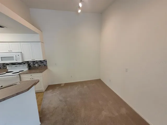 a kitchen with a sink cabinets and stainless steel appliances