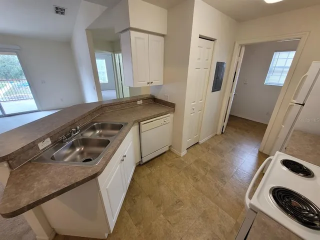 a kitchen with a stove and a refrigerator