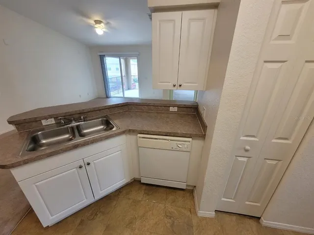 a utility room with cabinets washer and dryer