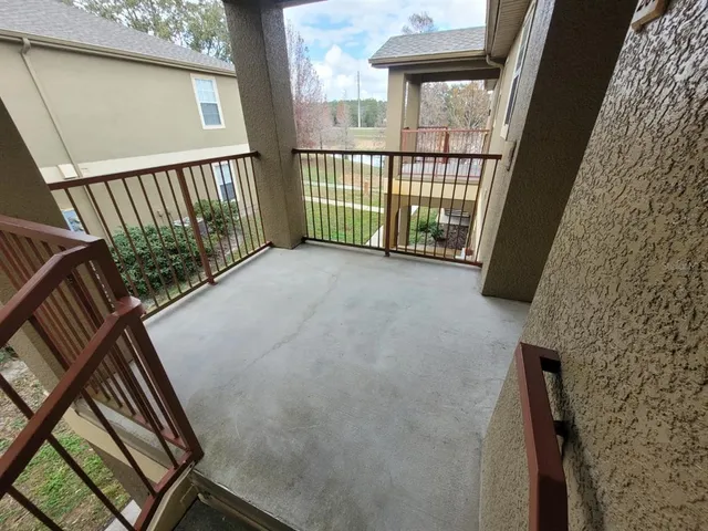 a view of a balcony with wooden floor