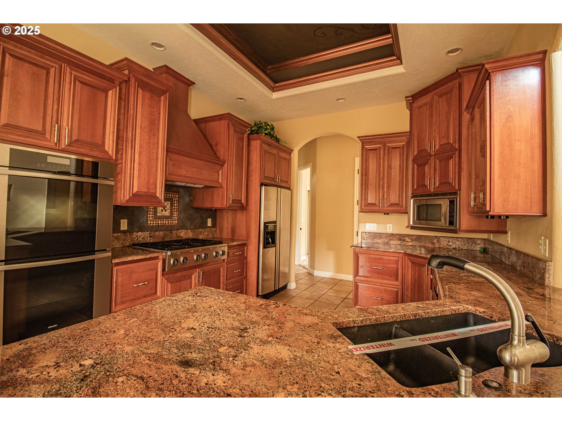 3760 Meadow View Drive Eugene, OR 97408 - Photo 19 of 46 a kitchen with stainless steel appliances kitchen island granite countertop a refrigerator stove and sink