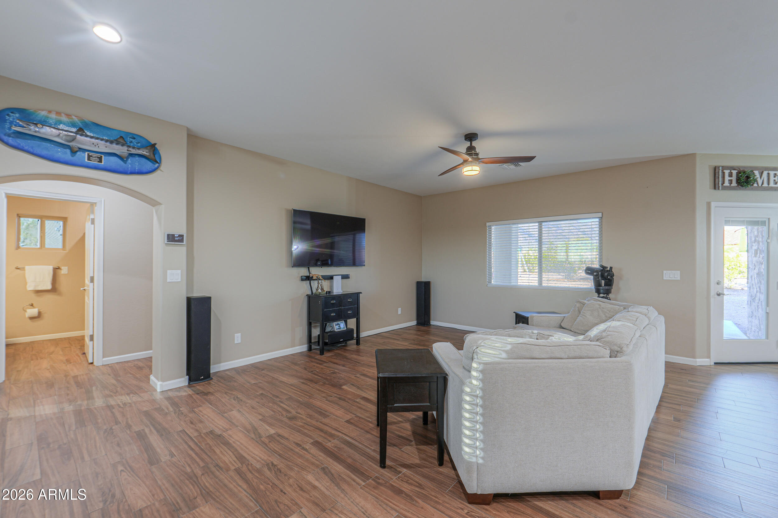 1487 South Mountain View Road Apache Junction, AZ 85119 - Photo 10 of 60 a living room with furniture and a flat screen tv