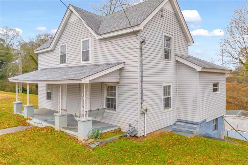 a view of a house with pool and chairs