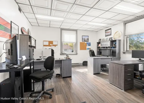 a living room with furniture a flat screen tv and a table