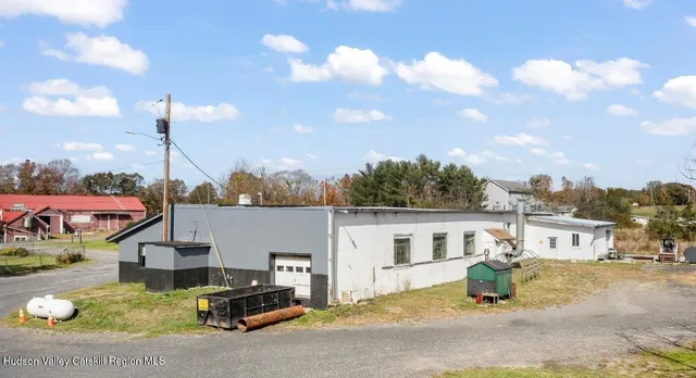 a front view of a house with a garden and balcony