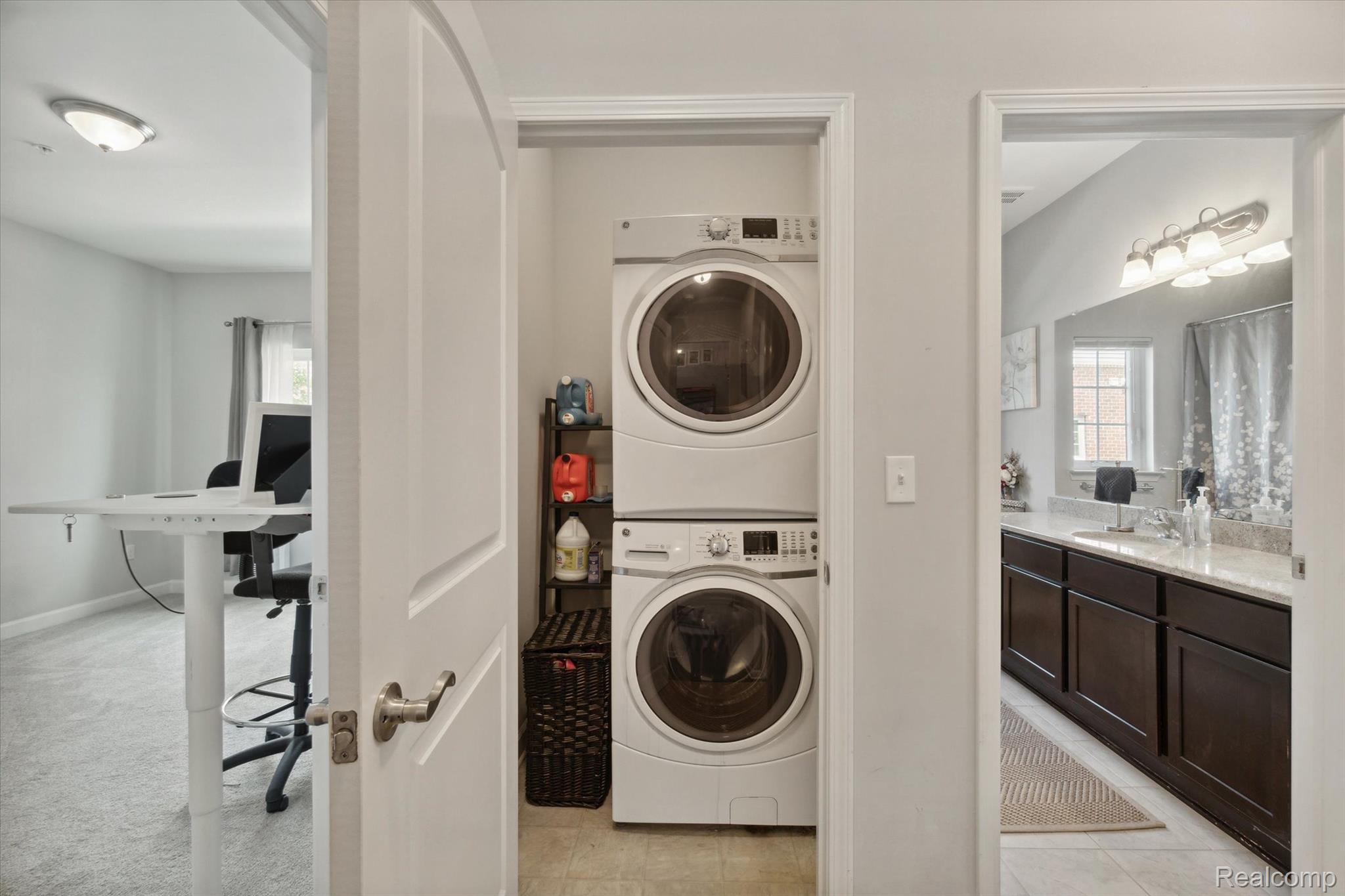 5662 Arbor Chase Drive Ann Arbor, MI 48103 - Photo 23 of 27 Dedicated laundry area featuring stacked appliances and durable tile flooring